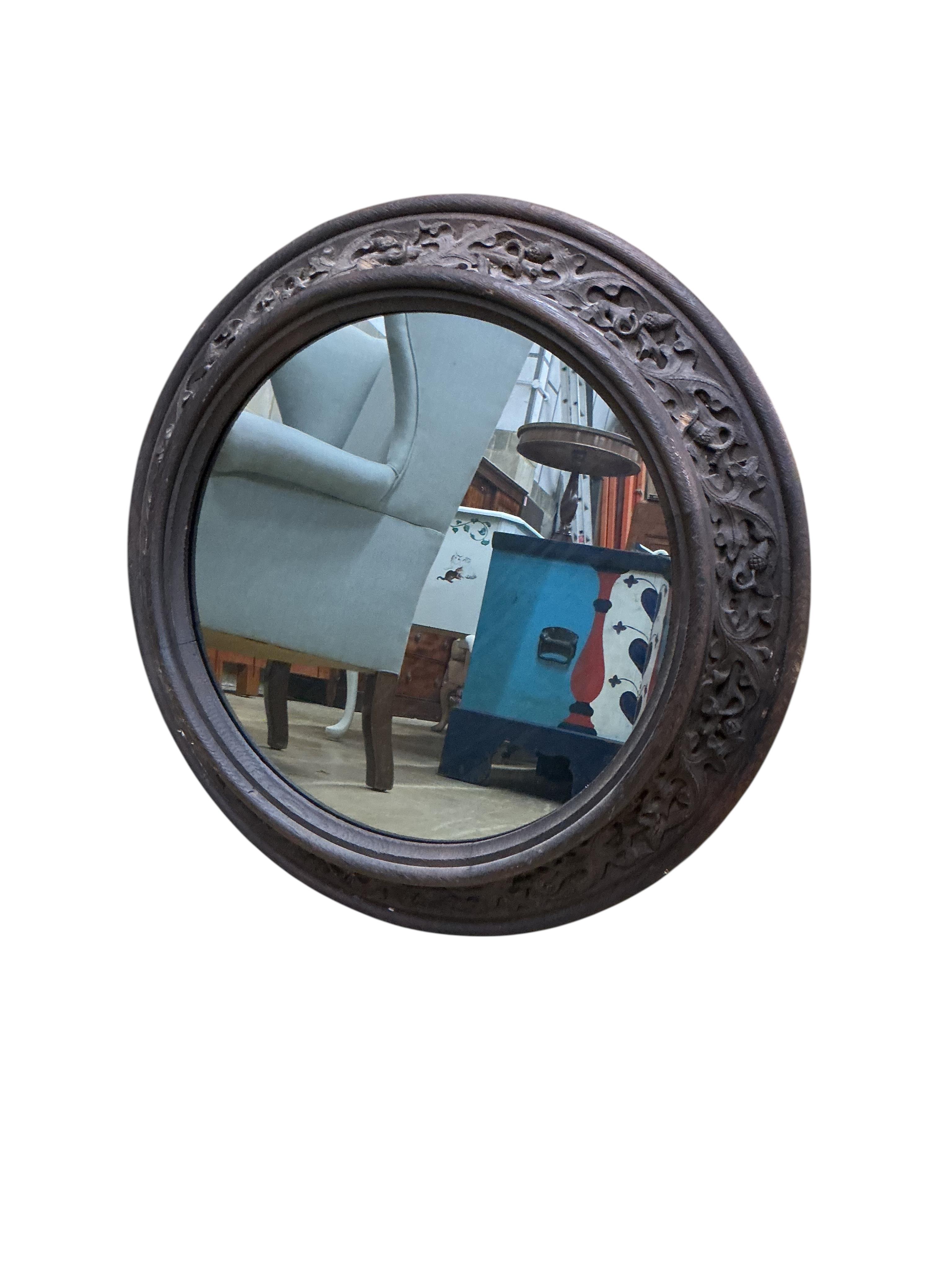 A pair of Victorian circular carved oak wall mirrors, with leaf and acorn borders, diameter 60cm